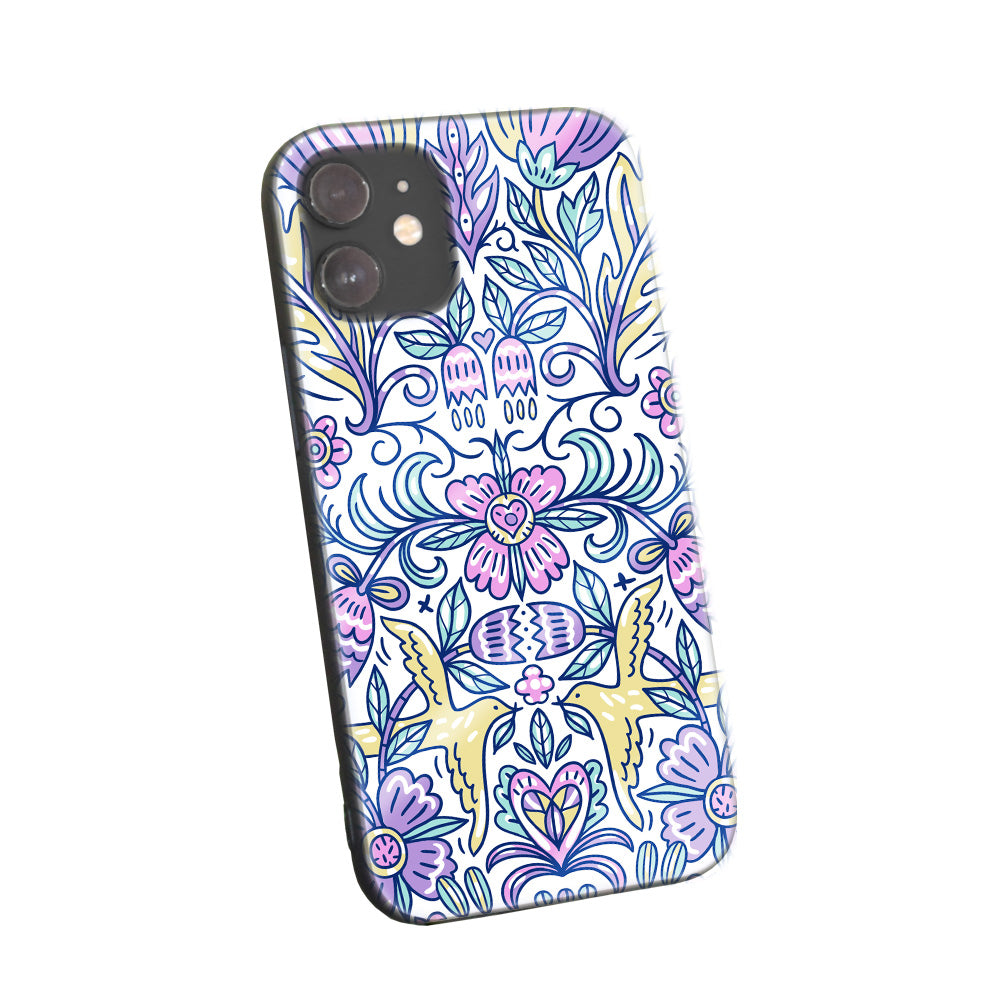 Phone case with intricate, colorful bohemian-inspired patterns on a light background